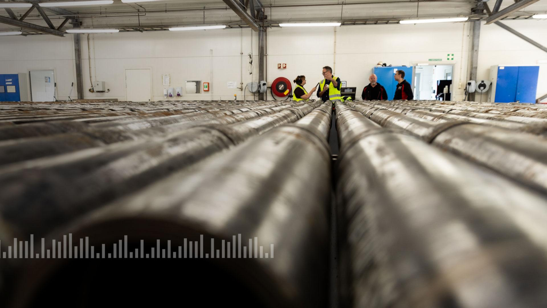 Tight view of pipes with people in the background