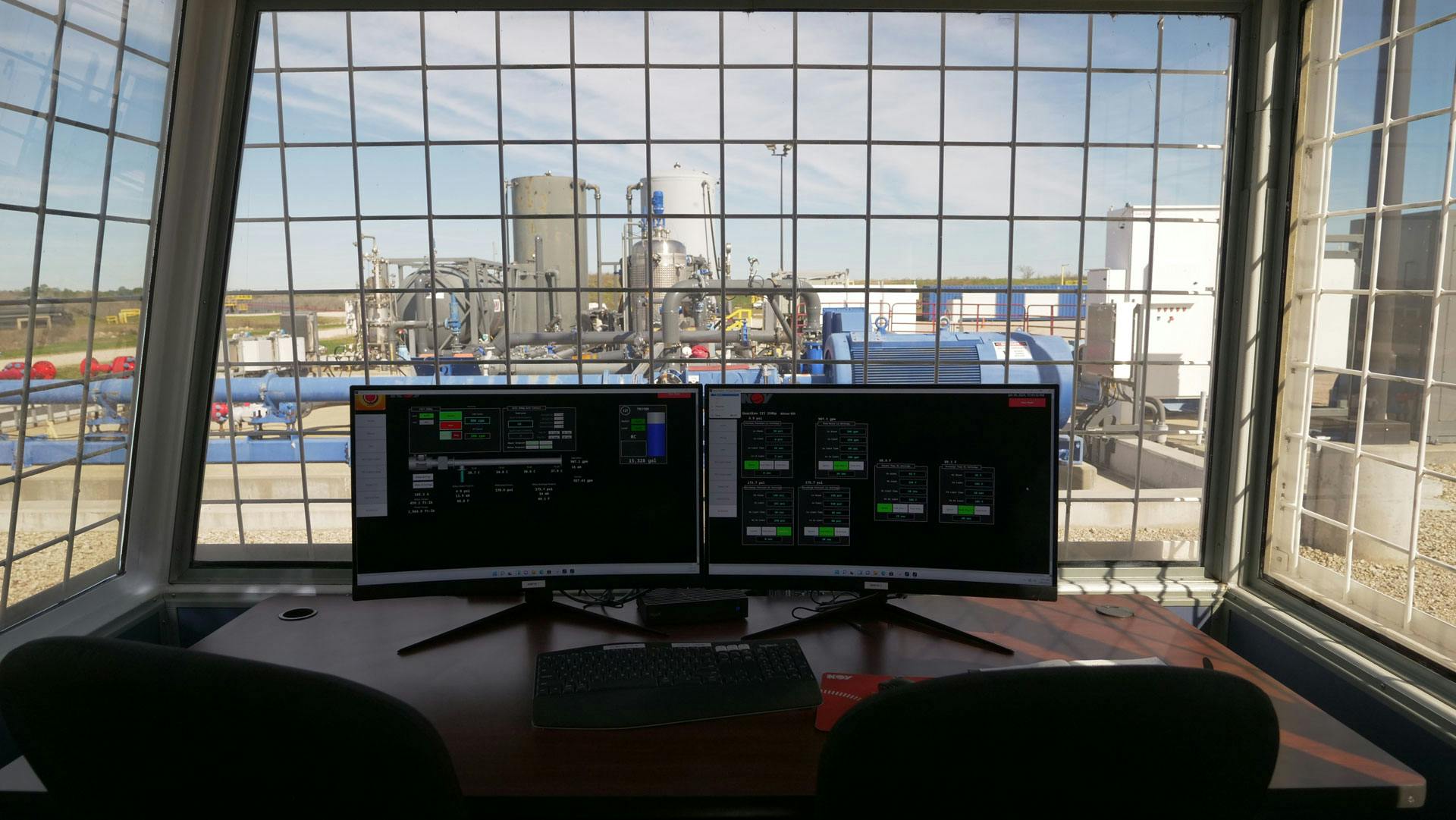 Two digital screens showcasing Guardian VFD overlooking the completions and production 'pad' at Springett Technology Center.