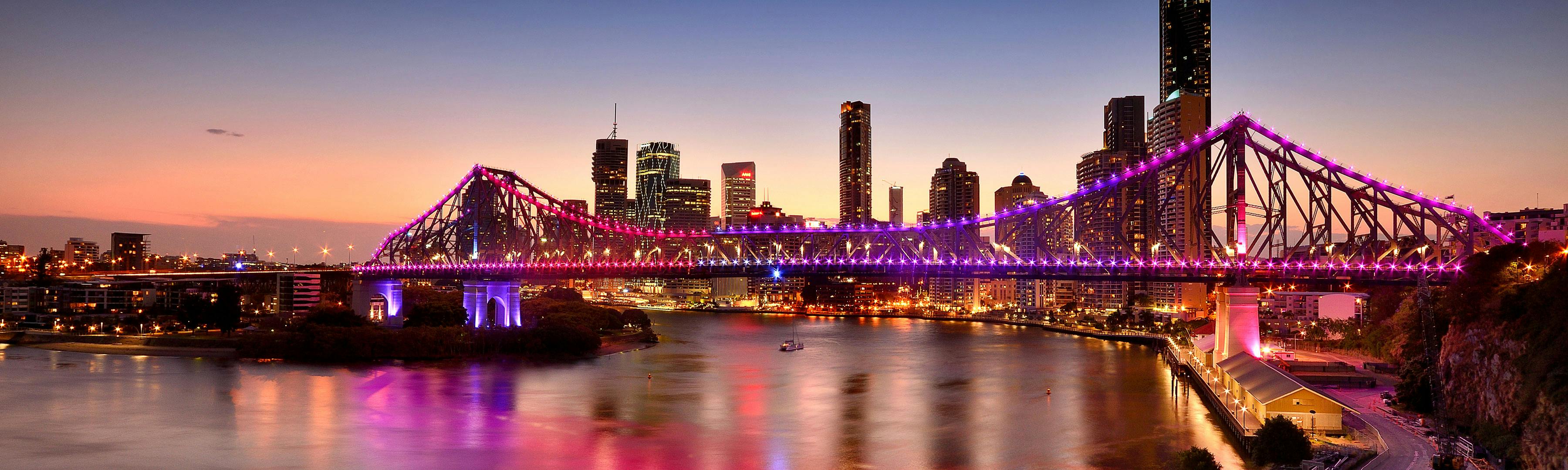 Skyline of Brisbane, Australia at dusk, featuring The Story Bridge