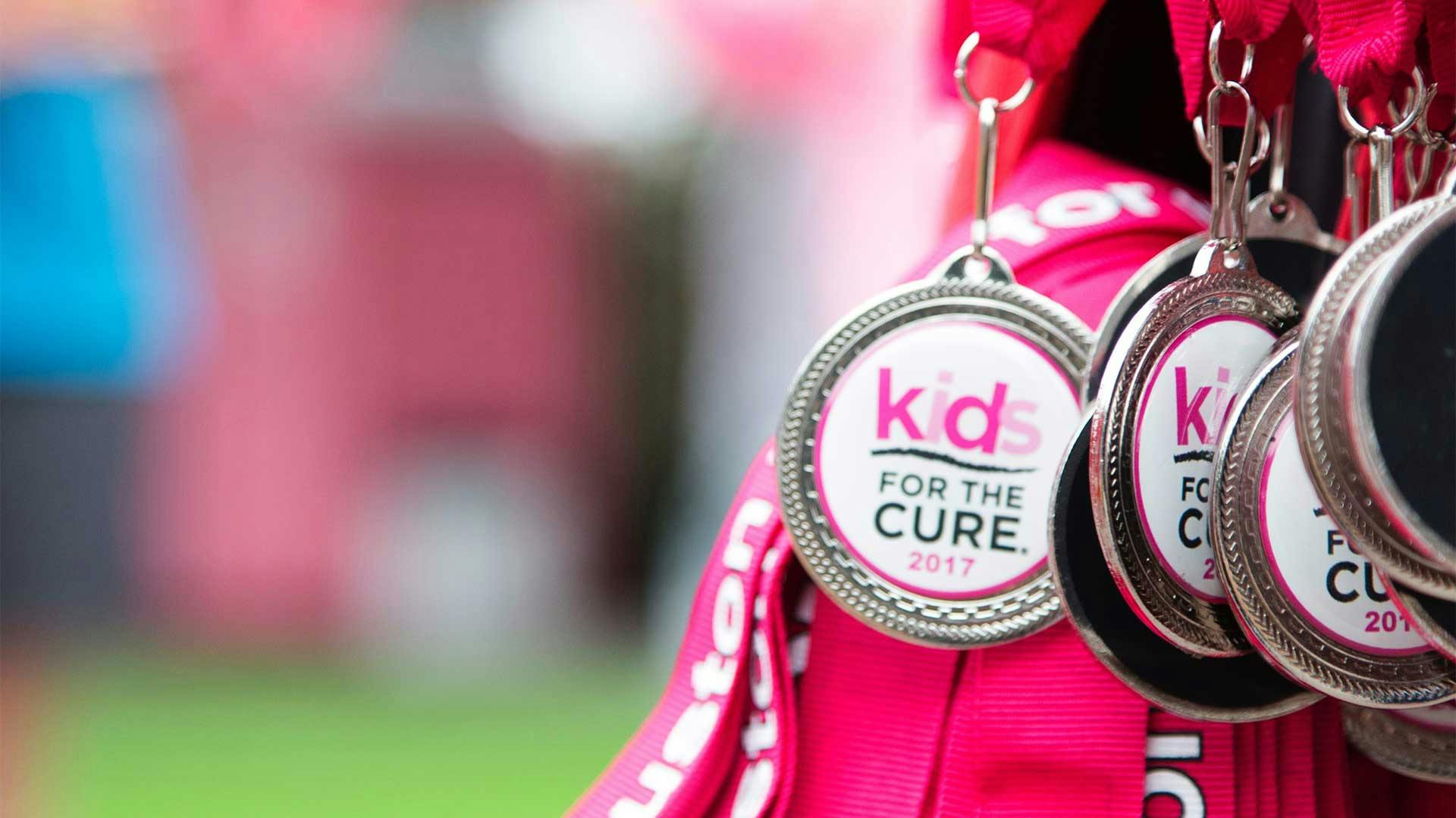 Close up of several Susan G Komen medals that say "Kids for the Cure 2017"