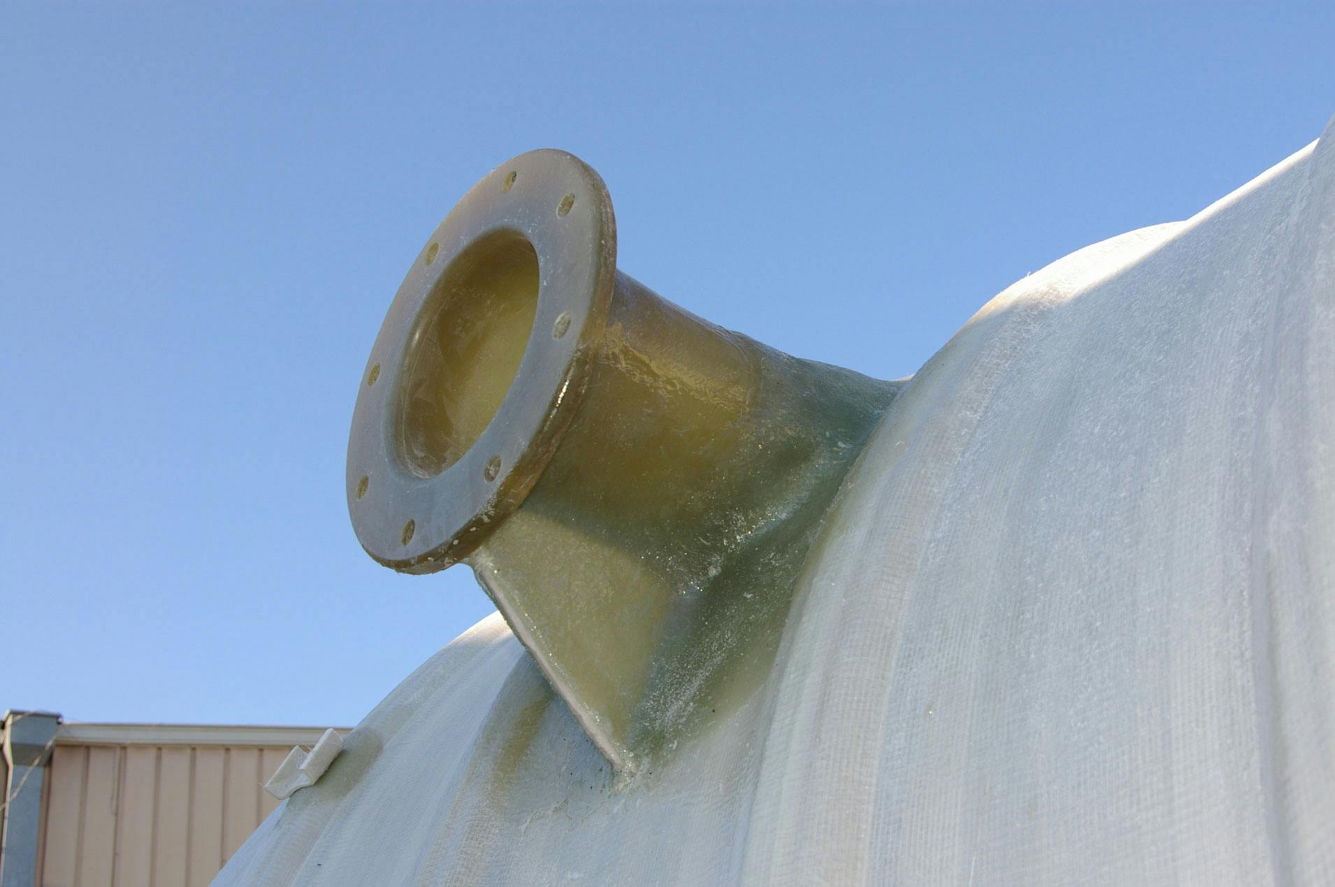 Fiberglass flanged nozzle on a tank at the manufactoring facility.
