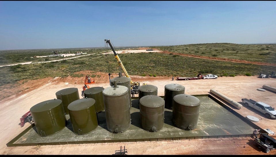 Oil and gas fiberglass tanks being installed