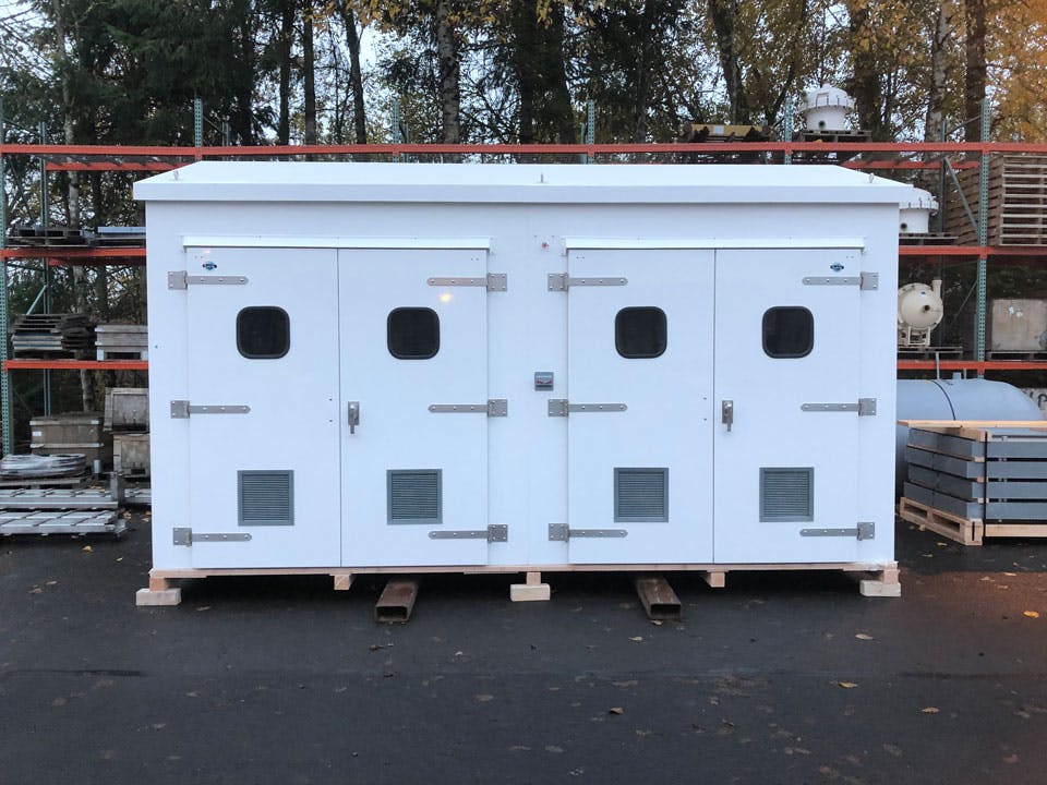 Large white ribbed wall shelter, with two sets of double doors