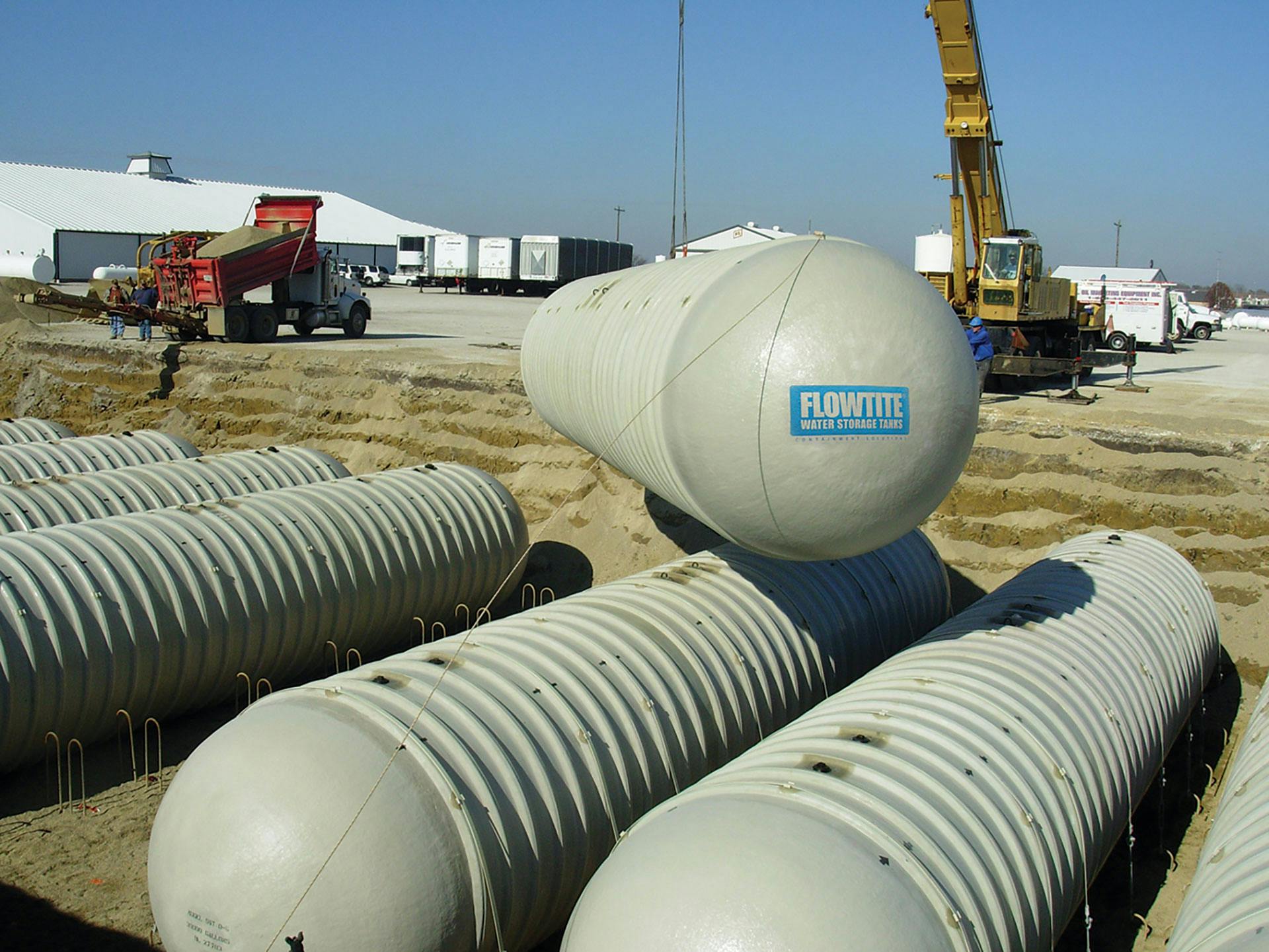 Flowtite stormwater tanks being installed underground with use of a crane
