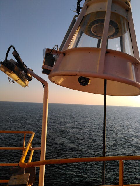 Close up of an Anti-Sway Rotator with the sea at dusk in the background