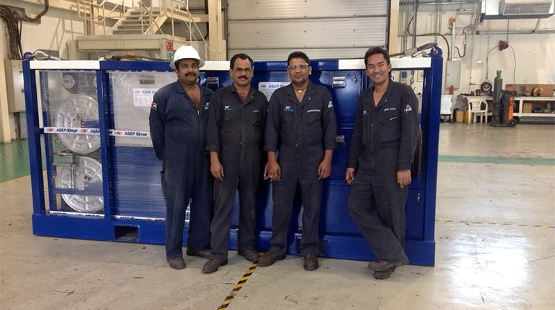 Four NOV technicians pose in front of a piece of refurbished and recertified Elmar equipment